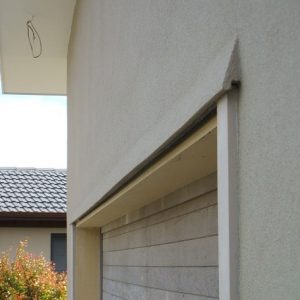 Eyebrow over a garage door to deflect rainwater