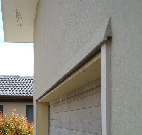 Eyebrow over a garage door to deflect rainwater